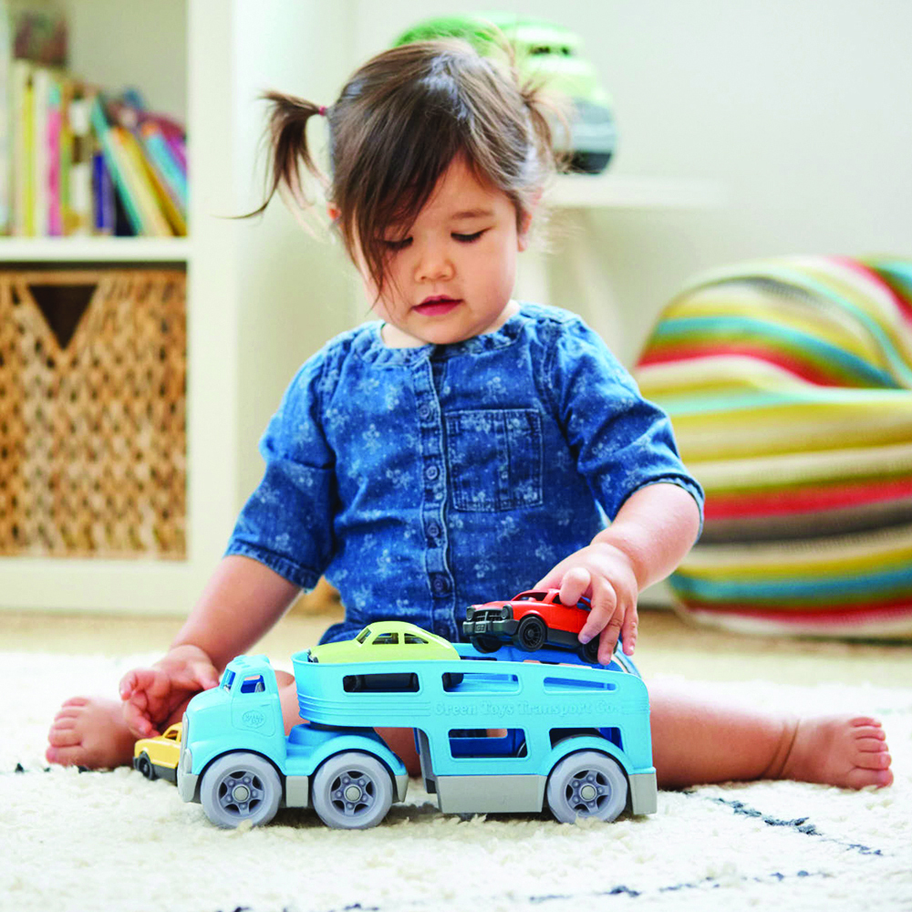 girl playing with car carrier